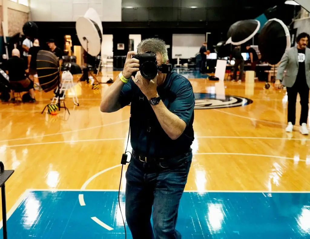Professional headshot photographer at American Airlines Center during a Dallas Mavericks headshot session