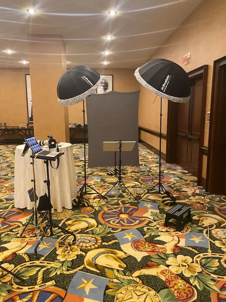 Portable professional headshot studio with two Profoto lights, gray backdrop, and camera workstation at the Gaylord Texan in Grapevine, Texas