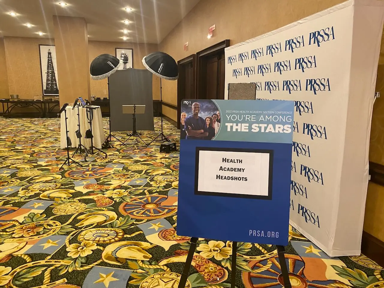Branded PRSSA Health Academy headshot station with portrait lighting and conference signage at the Gaylord Texan